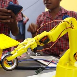 Student building a robotic arm