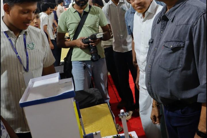Educators reviewing a student electronics project